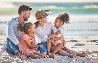 Buy stock photo Interracial family, beach vacation and travel with children and parents sitting in sand enjoying summer holiday in maldives. Man, woman and girl kids having fun and feeling happy on a tropical trip 