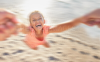 Buy stock photo Kids, children and girl swinging on the beach while playing, laughing or having fun with a parent against the sand with motion blur. Happy, smile and excited with a female child smile on the coast