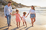 Family, children and beach of kids, mother and man holding hands on sea sand. Summer vacation of happy people with a smile in nature with relax happiness walking by the ocean water in the sun