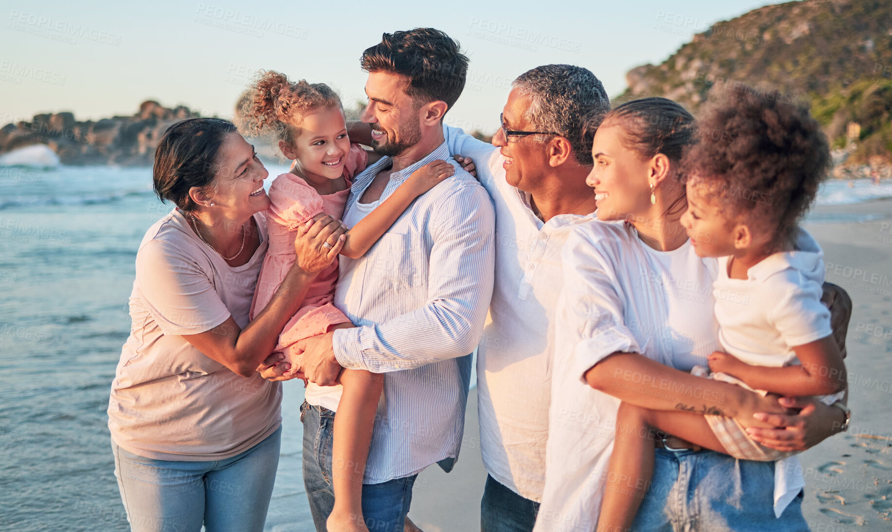 Buy stock photo Happy big family, love and beach holiday in Brazil, vacation or summer trip. Travel, relax and mom, dad and grandparents with girls smile walking, bonding and caring on ocean, sea and sandy shore.