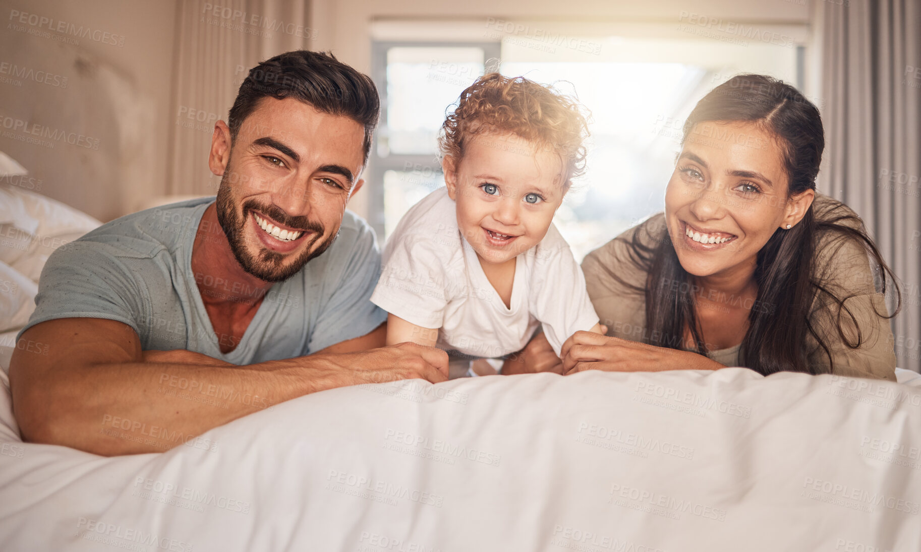 Buy stock photo Mother, father and child bonding in bedroom happy, love and care together in morning at family home. Portrait of joy, excited and young parents of mom, dad and youth son smile with happiness at house