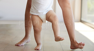 Buy stock photo Baby, learning and walking with a child taking its first steps with his mother to learn to walk at home. Feet, legs and balance with a kid stepping forward for growth and development in the house