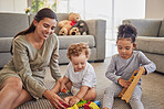 Family, mother and children playing with toys for development, education and childcare creative learning. Happy mom teaching and developing a young baby and kindergarten toddler at home on a weekend