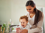 Mother, boy and washing hands help in water as fun covid bacteria cleaning and morning house hygiene wellness. Mom, woman or parent and child by bathroom sink in Italy home safety healthcare skincare