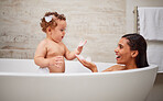 Mother, baby and bath in bathroom in home, health and cleaning. Mom, parent and child or kid bathing in bathtub, relax and spending quality free time with mama, bonding and care, support and trust