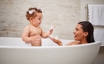 Buy stock photo Mother, baby and bath in bathroom home, health and cleaning. Mom, parent and child or kid bathing in bubble bathtub, relax and having fun time with mama, bonding or care with healthy hygiene skincare