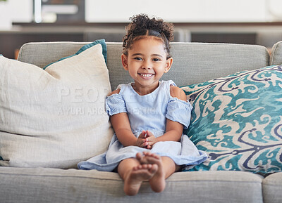 Buy stock photo Children, girl and happy with a cute female kid on a sofa in the living room of her home alone. Kids, cute and smile with a portrait of an adorable little female child in a colombia house in the day