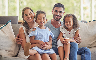 Buy stock photo Happy, smile and portrait of a family bonding in the living room to relax on the sofa together. Happiness, care and parents sitting and holding their girl children with love on a couch at home.