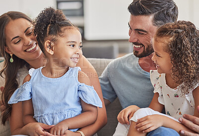 Buy stock photo Family, smile and love of children for their mom and dad while sitting together in the lounge at home sharing a special bond. Happy interracial man, woman and girl kids hug their parents in Brazil