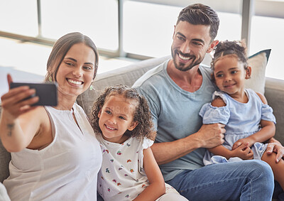 Buy stock photo Family selfie, interracial smile and parents with phone for social media with children, happy on the sofa in house and relax with kids in home. Girl siblings taking photo with mother and father