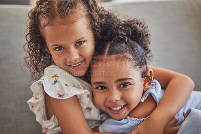 Buy stock photo Happy, smile and portrait of sisters hugging while sitting on a sofa in the living room at the family home. Happiness, love and girl siblings from puerto rico bonding while relaxing on couch together