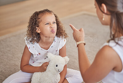 Buy stock photo Angry, adhd and child being rude to her mother showing anger, bad behaviour and attitude problems at home. Mean, moody and girl with tongue out making parenting difficult for an annoyed and upset mom