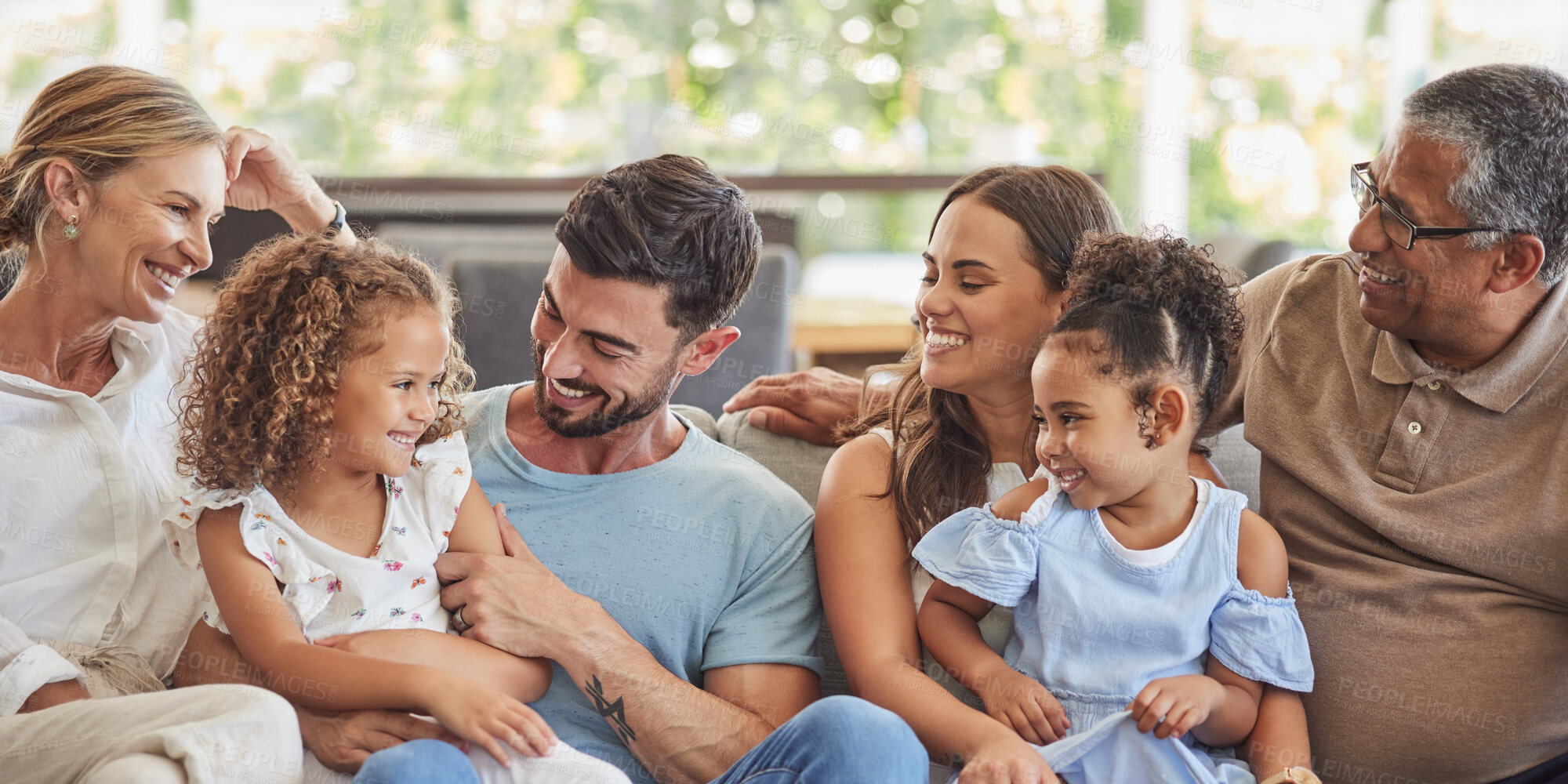 Buy stock photo Happy, smile and big family on a sofa to relax in the living room together at home. Diverse grandparents, parents and children from Brazil with happiness, love and bonding sitting on a couch.