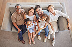 Love, smile and diversity portrait of happy family relax on living room sofa and bonding during annual family reunion above view. Grandparents, parents and children enjoy fun quality time together