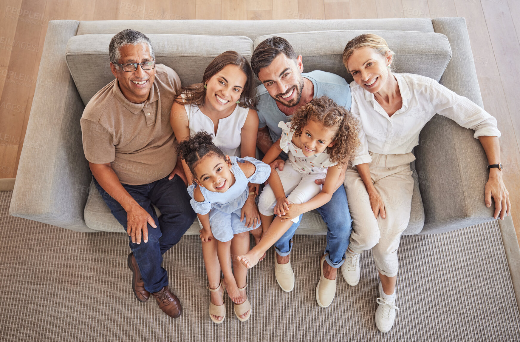 Buy stock photo Love, smile and diversity portrait of happy family relax on living room sofa and bonding during annual family reunion above view. Grandparents, parents and children enjoy fun quality time together
