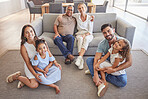 Interracial family portrait, children with grandparents with love, hug and smile together. Happy elderly mother, father and kids together with adult children on the floor in the living room of house