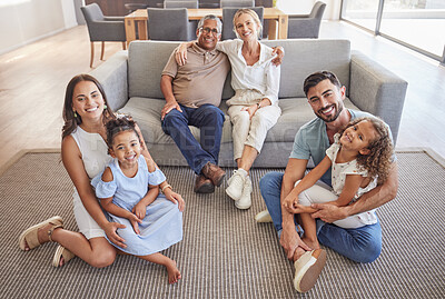 Buy stock photo Interracial family portrait, children with grandparents with love, hug and smile together. Happy elderly mother, father and kids together with adult children on the floor in the living room of house