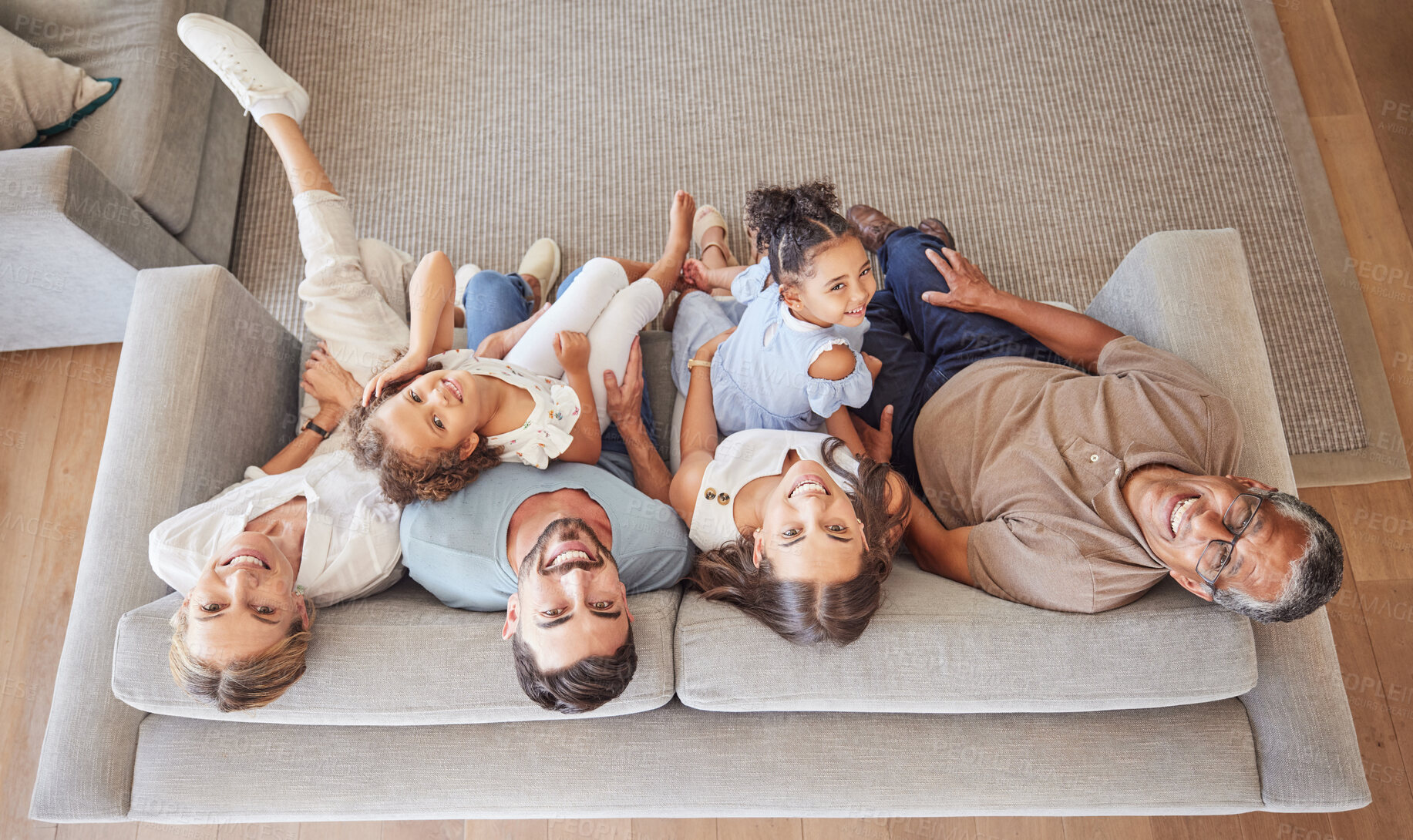 Buy stock photo Family, children and love with kids from above next to grandparents and parents on a sofa in the living room of their house. Portrait, smile and happy with a girl, sister and senior relatives at home