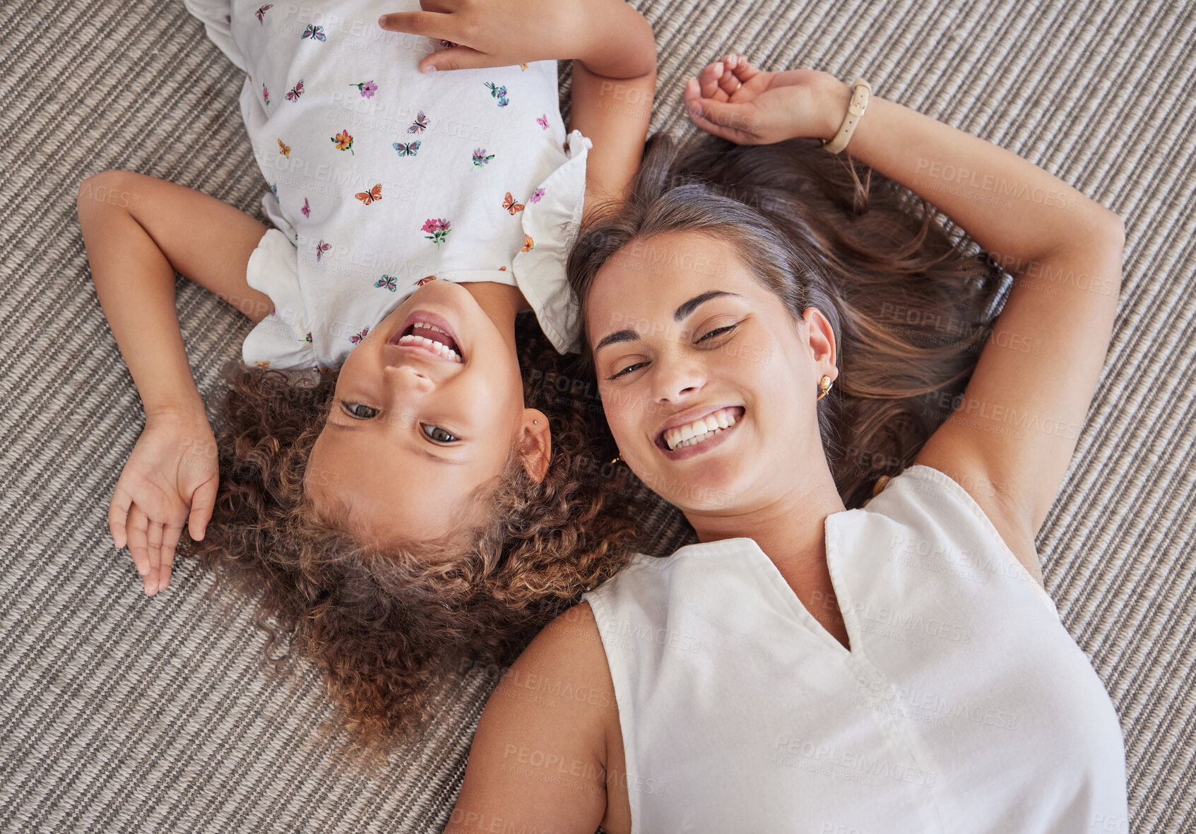 Buy stock photo Family, children and love above a girl and mother lying on a bed in the bedroom of their home together from above. Kids, happy and smile with a woman and her cute daughter in their house to relax