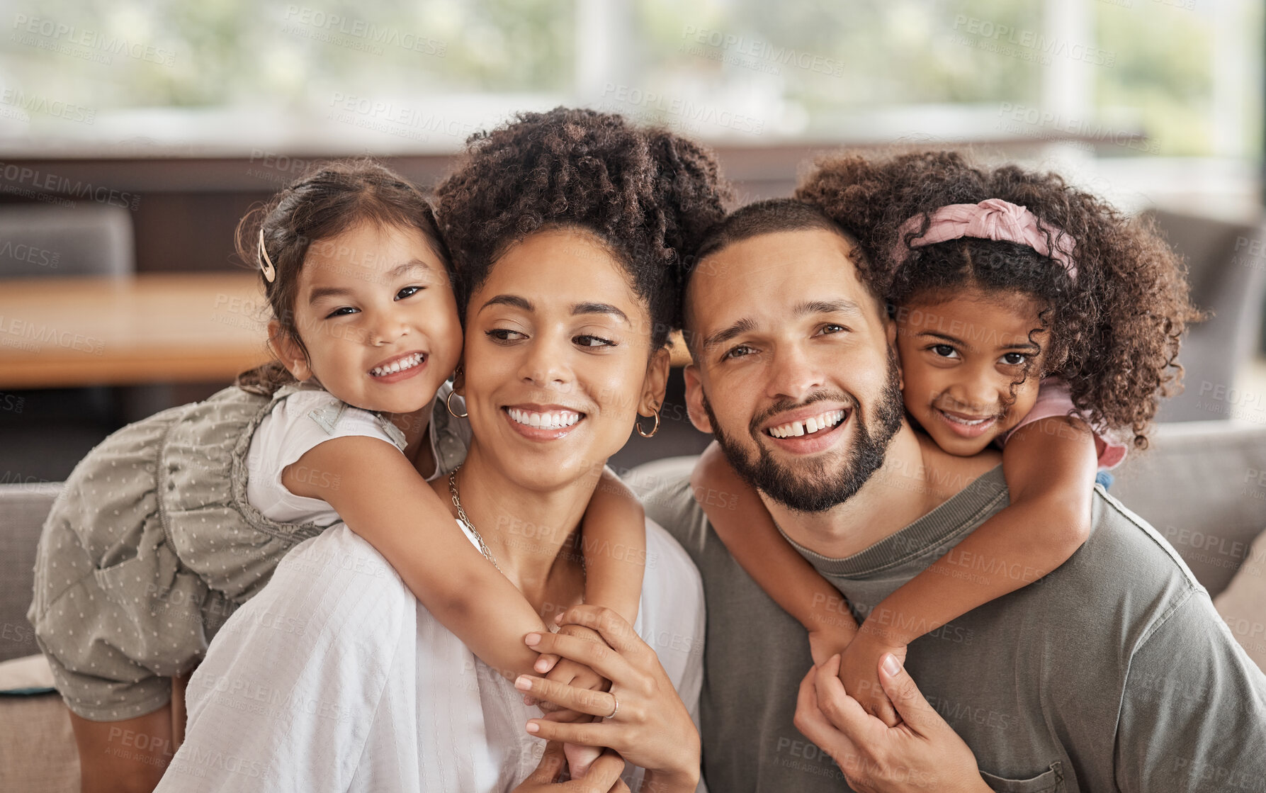 Buy stock photo Portrait of family, smile and love while relax together on a sofa at home. Carefree playful little children or girl hug arms around loving parent. Happy kids bonding with mom and dad on sofa or couch