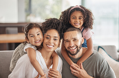 Buy stock photo Happy, smile and portrait of an interracial family sitting on a sofa in the living room at home. Happiness, love and adoptive parents bonding, embracing and relaxing with their children in the lounge
