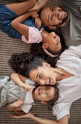 Buy stock photo Love, above and happy relax family having fun, bond or enjoy quality time together in home living room. Smile, laugh and happiness for youth kids or children with mom, dad or parents on the floor