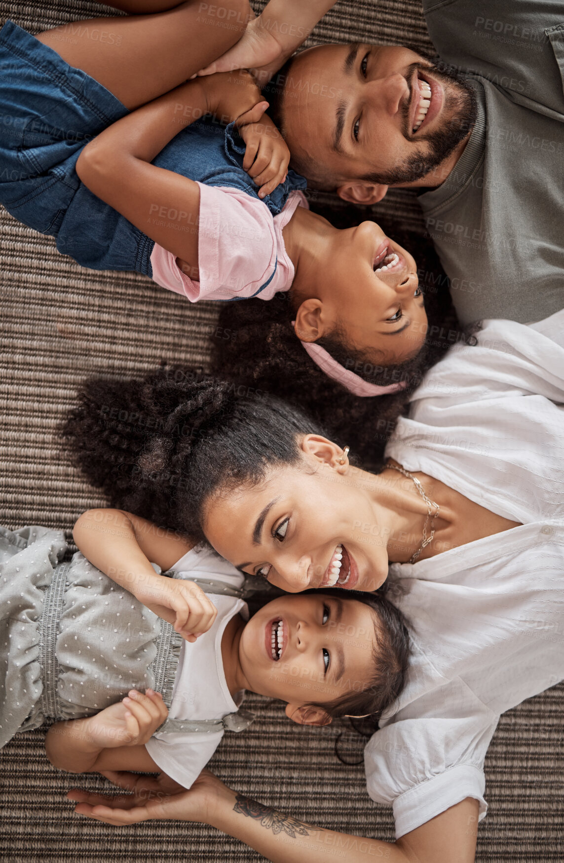 Buy stock photo Love, above and happy relax family having fun, bond or enjoy quality time together in home living room. Smile, laugh and happiness for youth kids or children with mom, dad or parents on the floor