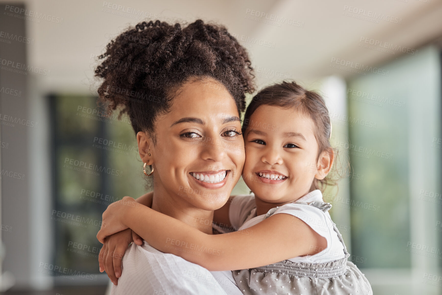 Buy stock photo Family, love and bond of mother and daughter sharing a hug, happiness and having fun on mothers day in their puerto rico home. Portrait and smile of woman and foster girl child bonding after adoption