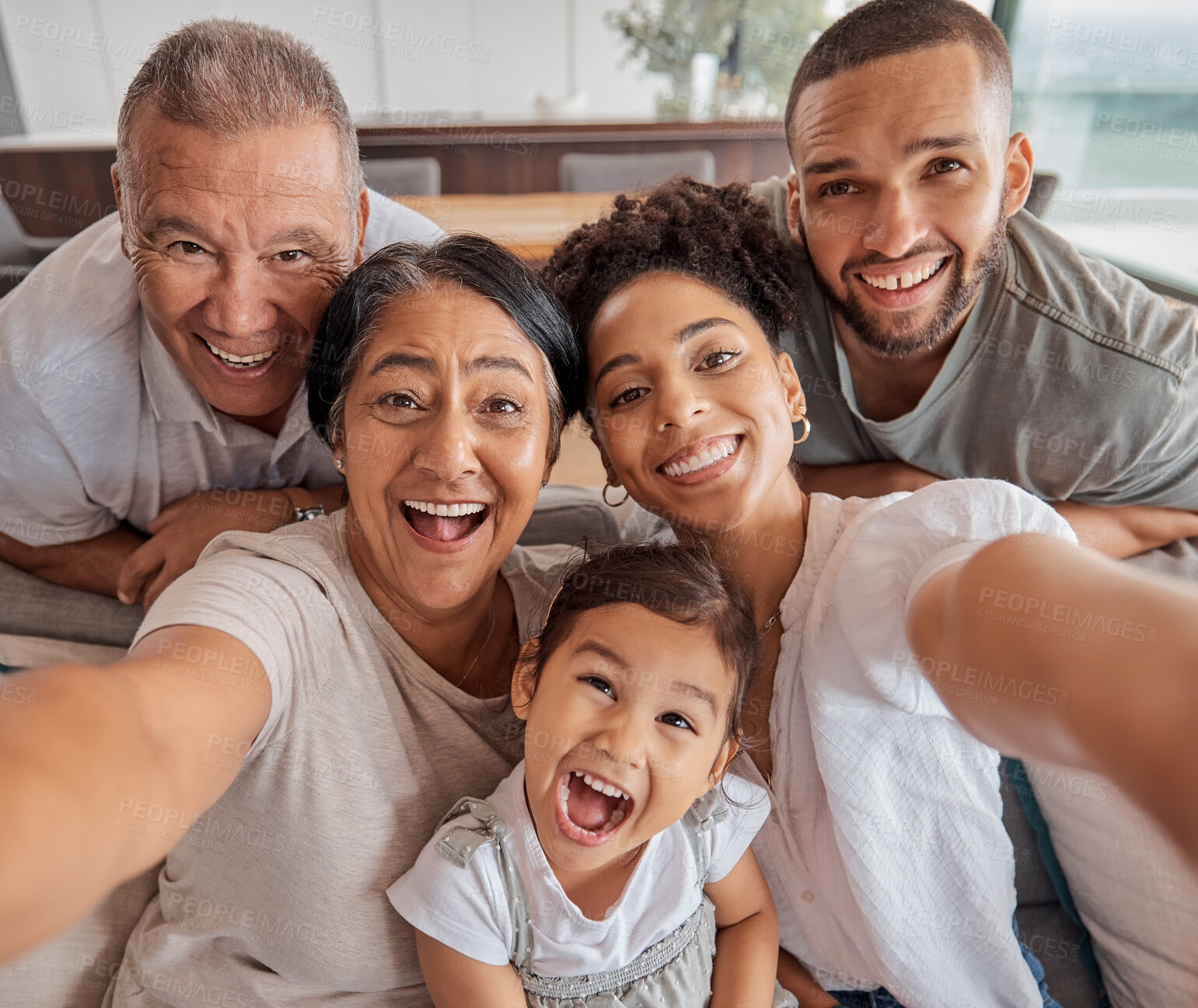 Buy stock photo Crazy selfie, portrait family and grandparents being funny with love for children on the living room sofa in house. Girl, mother, father and senior people taking photo with comic face in home