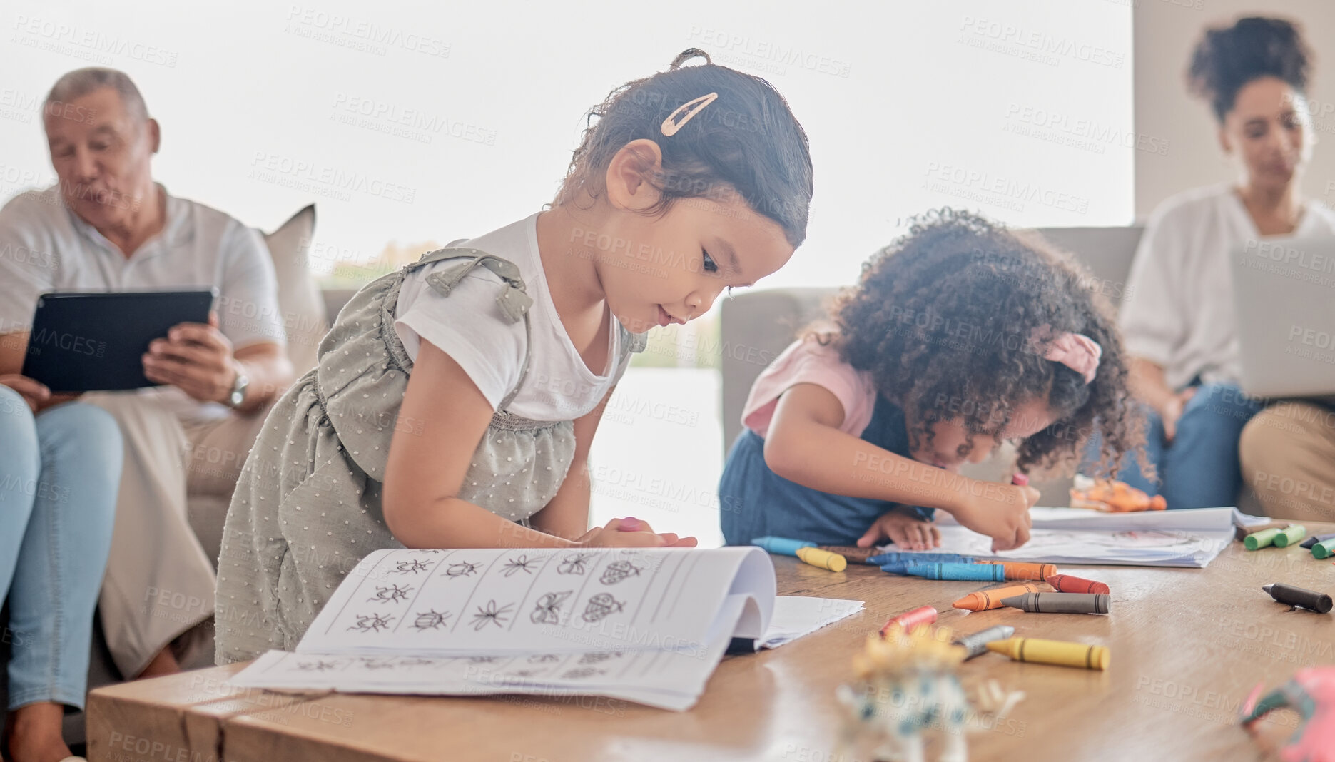 Buy stock photo Book drawing, children learning and parents working on technology while kids do art in living room of house. Girl siblings being creative for learning while family does work on tech on sofa in lounge