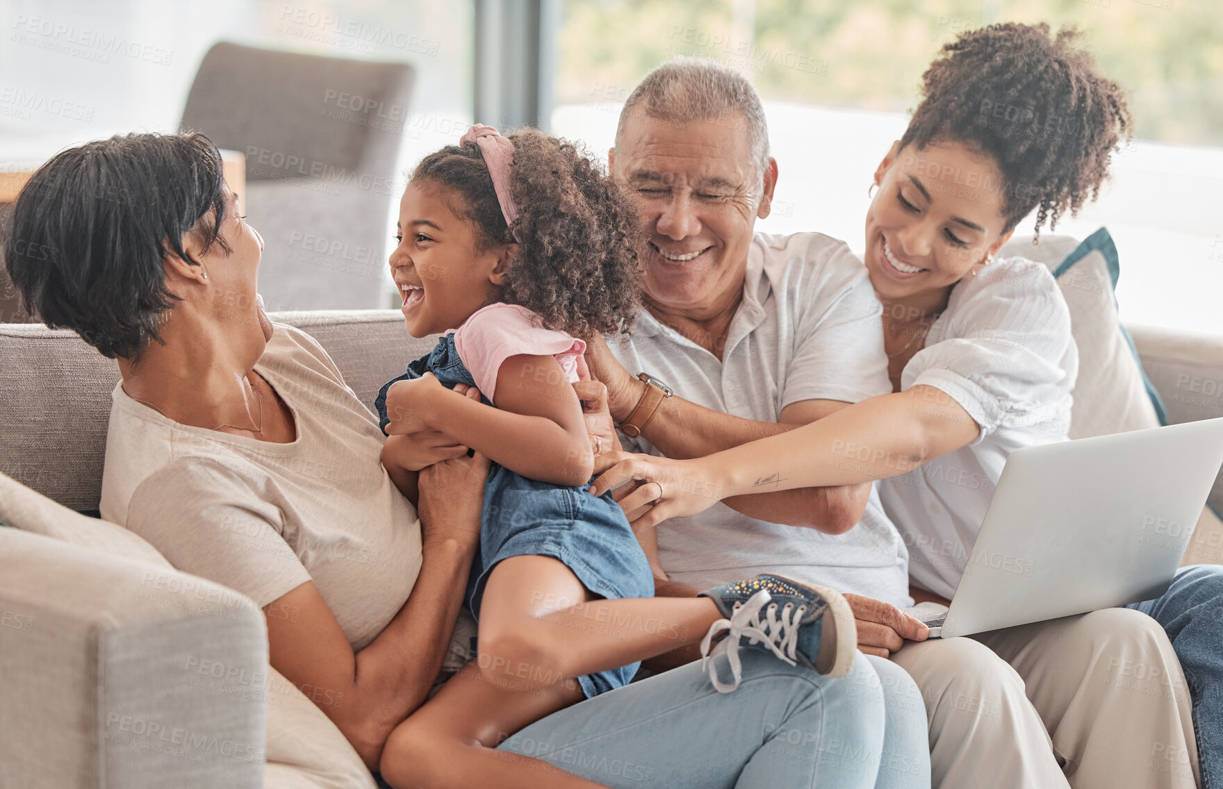Buy stock photo Big family, love and support while playing with child and using laptop to watch on internet while on home sofa with parents and grandparents in brazil. Happy man, women and girl kid together to bond 