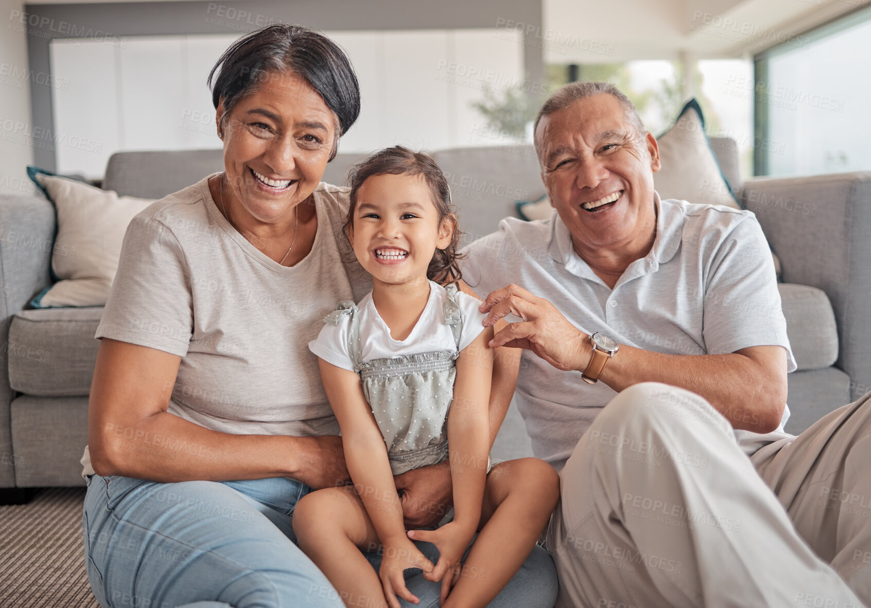 Buy stock photo Grandparents, girl and floor in house, smile and playing while in bonding together. Grandmother, grandpa and child on carpet in living room, smile and family home, for visit or holiday in Jakarta