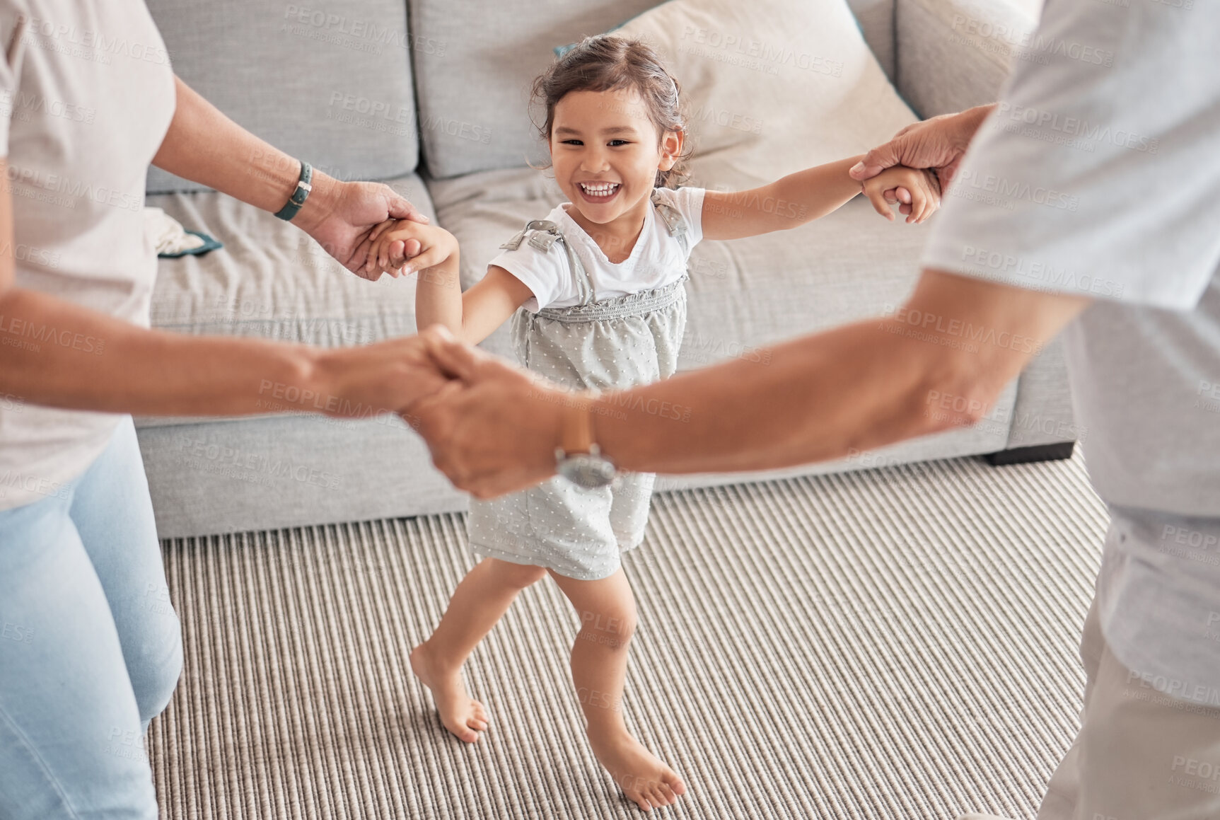 Buy stock photo Happy family, child and playing circle game while bonding, fun and holding hands with energy, happiness and joy with energetic asian girl. Kid, play and support with man and woman doing dance at home