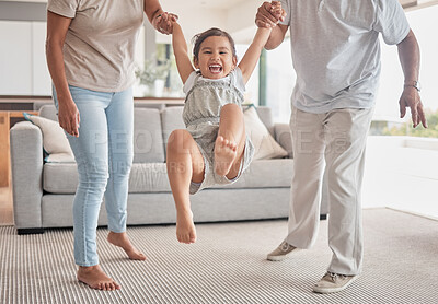 Buy stock photo Family, child holding hands and swinging in fun living room play time, childhood and bonding at home. Happy kid smile in playful childcare and joyful happiness with loving parents or grandparents