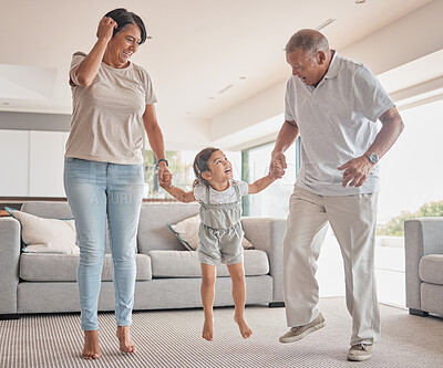 Buy stock photo Mexico grandparents with child jump in living room home for fitness, wellness or growth development and holding hands for love, support and care. Happy elderly family with girl kid for fun dance game