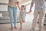 Kids, family and love with a girl, mother and father holding hands in the living room of their home. Children, smile and care with a happy female child and parents in a house on a weekend morning