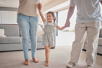 Buy stock photo Kids, family and love with a girl, mother and father holding hands in the living room of their home. Children, smile and care with a happy female child and parents in a house on a weekend morning