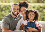 Happy family, mother and father with their child love being home for bonding, quality time and relaxing together. Smile, mom and dad enjoy hugging and connecting with their young girl on the weekend