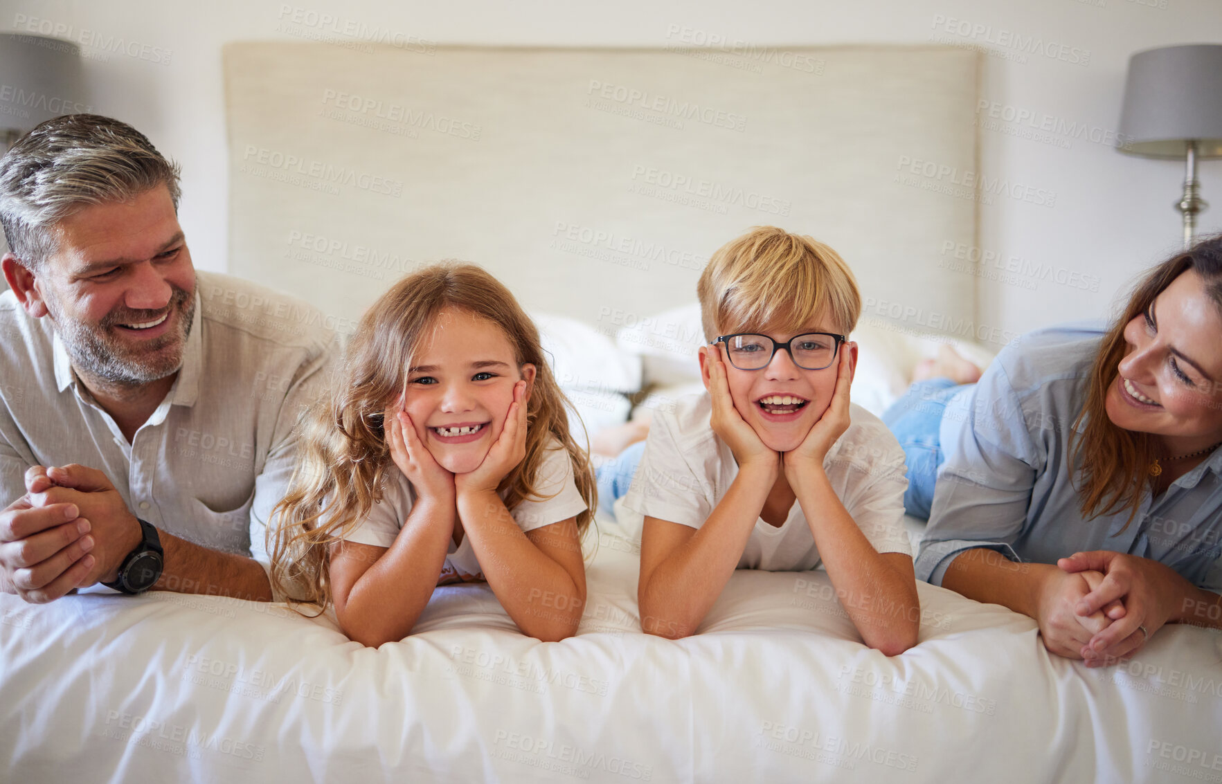 Buy stock photo Relax, happy and love with family in bedroom together after wake up in the morning for care, support and sleeping. Smile, lifestyle and portrait of young children, mother and father lying on bed 