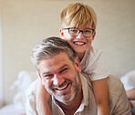 Family, children and love with a man and his child at home, laughing and having fun with a smile together. Kids, happy and smile with a cute boy and his father playing in a bedroom of their house