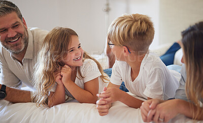 Buy stock photo Happy family relax on a bed, kids, smile and playing in a bedroom together. Young loving parents enjoying free time with their children, being playful, laugh and happy with love and care in home