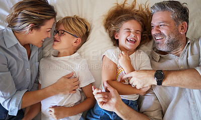 Buy stock photo Top view, parents and children on bed relax, fun and laugh together on weekend. Family, love and happy man and woman in bedroom with kids, daughter and son being playful, embrace and bonding at home.