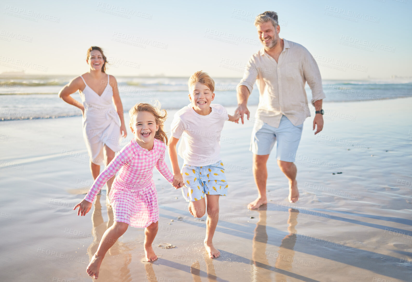 Buy stock photo Travel, running and happy with family at the beach on Bali holiday for love, summer and freedom. Smile, support and holding hands with parents and children for vacation, wellness and trust together