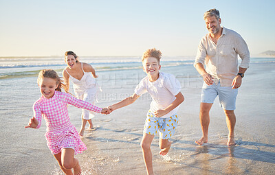 Buy stock photo Happy family running on the beach with mother, father and children holding hands for summer holiday, wellness and outdoor development. Mom, dad and kids with healthy fun energy by ocean or sea waves