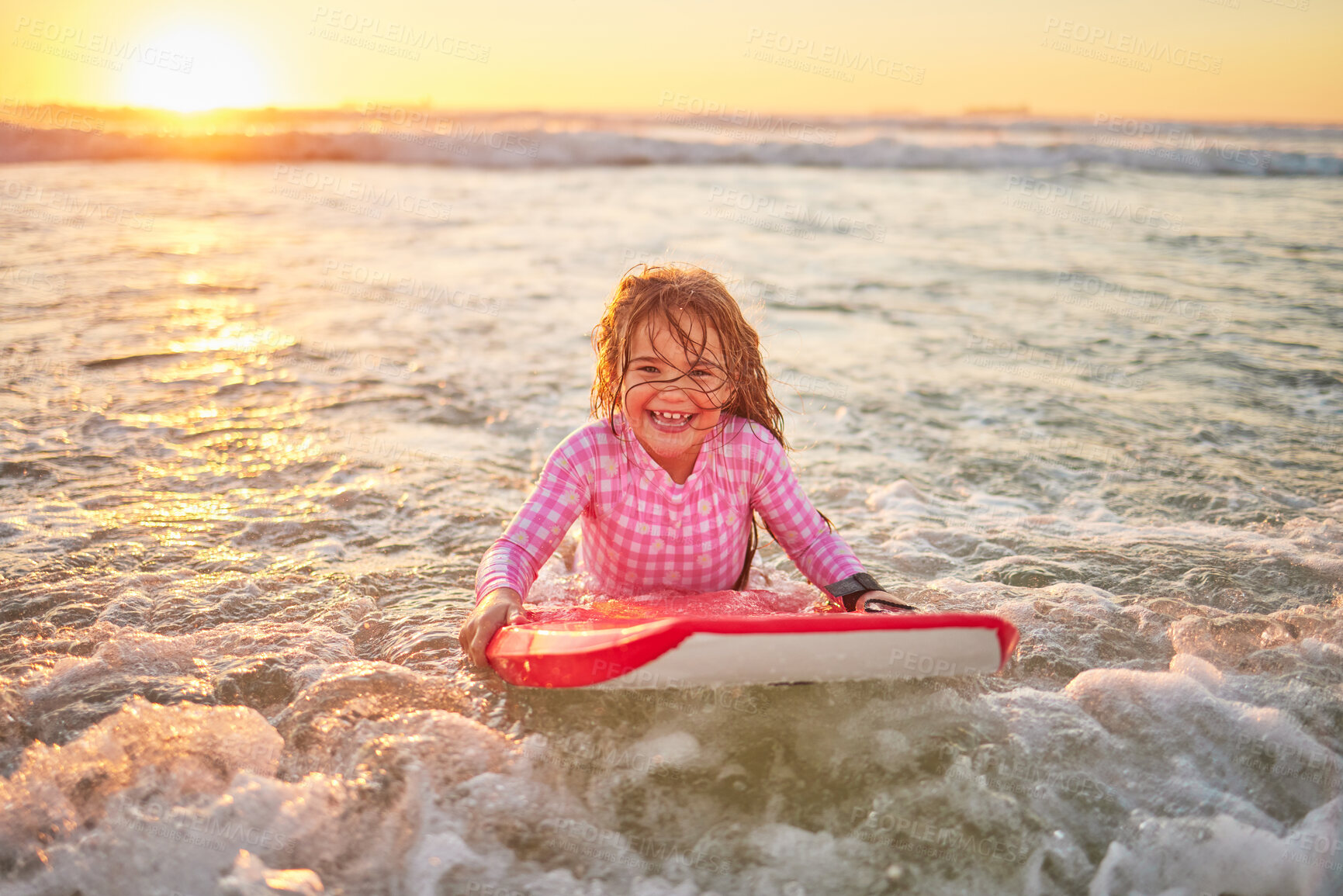 Buy stock photo Happy, beach and girl learning to surf for sport, motivation and hawaii summer vacation. Nature, travel and smile with child surfing on board for water sports, splash and wellness ocean holiday