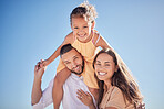 Happy, love and freedom with family against the blue sky together for relax, support and care. Smile, summer and girl on father shoulders with mother in the outdoor for lifestyle, youth and nature