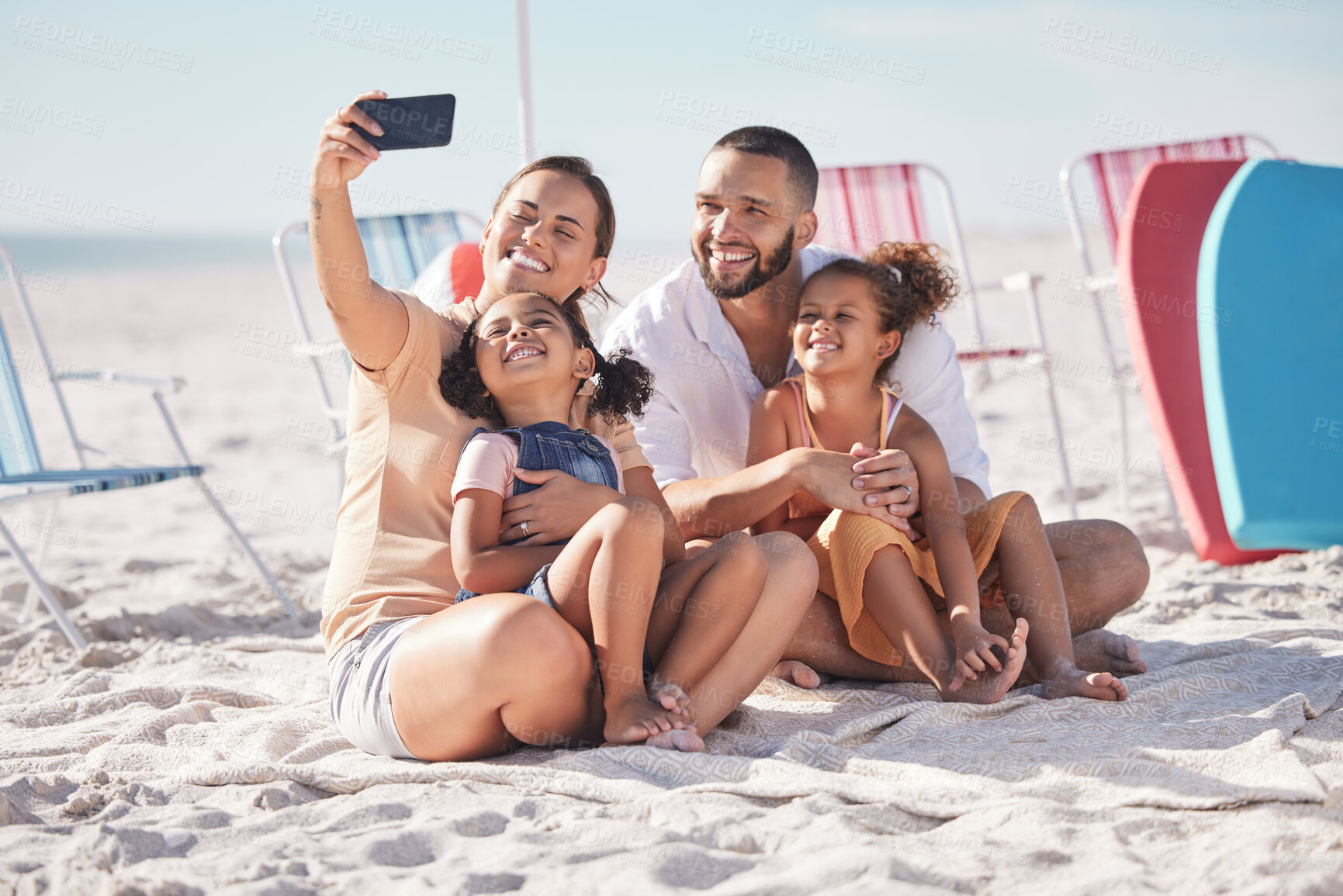 Buy stock photo Happy, family and beach selfie with smile together on summer vacation bonding and relaxing on the sand. Mother, father and children relax on sandy shore, holiday break or weekend smiling in happiness