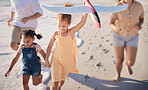 Happy, toys and beach children running, play or have family fun on Costa Rica holiday vacation. Love bond, travel and quality time for kids, sisters or friends with parents on sea water or ocean sand