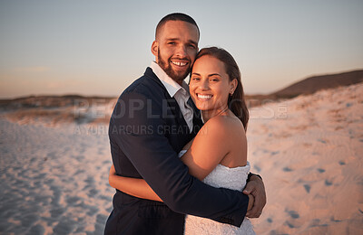 Buy stock photo Wedding, couple and love on beach at sunset with a bride and groom for ceremony, commitment and celebration. Newlyweds, man and woman embrace and hug on the sand for marriage and being romantic. 