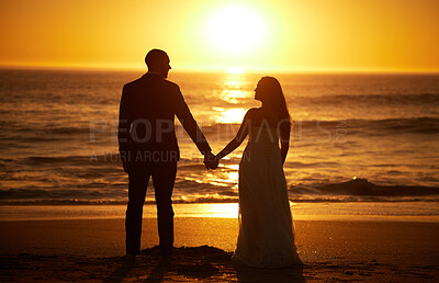 Buy stock photo Love, summer and couple at a beach at sunset, silhouette holding hands and bonding with ocean views in nature. Romance, travel and nature with man and woman enjoying sea honeymoon and romantic trip
